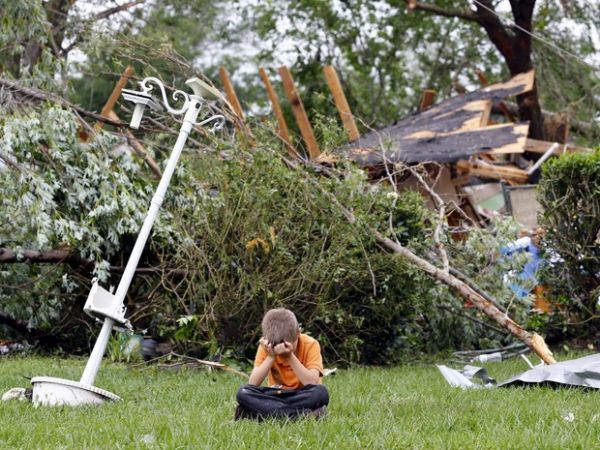 Charles Athrom, de 7 anos, chora em frente  sua casa destruda aps passagem de tornado na cidade de Van, no estado americano do Texas